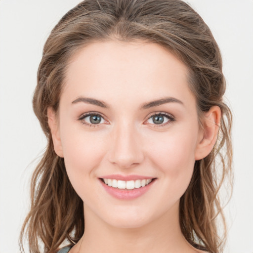 Joyful white young-adult female with long  brown hair and green eyes