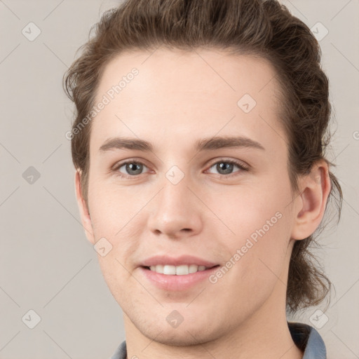 Joyful white young-adult female with short  brown hair and grey eyes