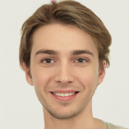 Joyful white young-adult male with short  brown hair and green eyes