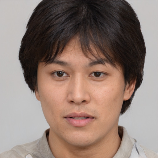 Neutral asian young-adult male with short  brown hair and brown eyes