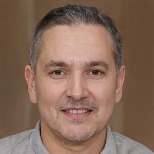 Joyful white adult male with short  brown hair and brown eyes