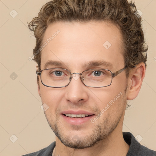 Joyful white young-adult male with short  brown hair and grey eyes