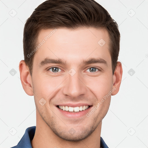 Joyful white young-adult male with short  brown hair and grey eyes