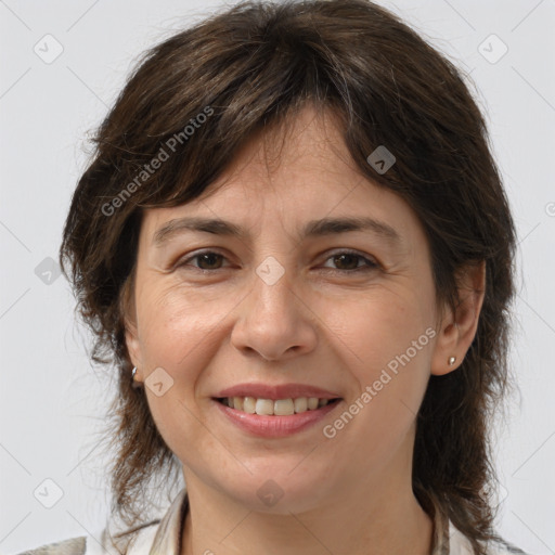 Joyful white adult female with medium  brown hair and grey eyes