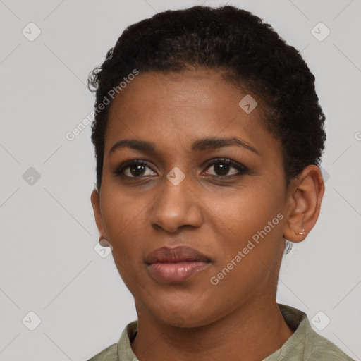 Joyful black young-adult female with short  black hair and brown eyes