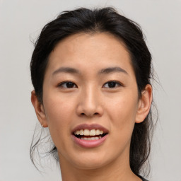 Joyful asian young-adult female with medium  brown hair and brown eyes