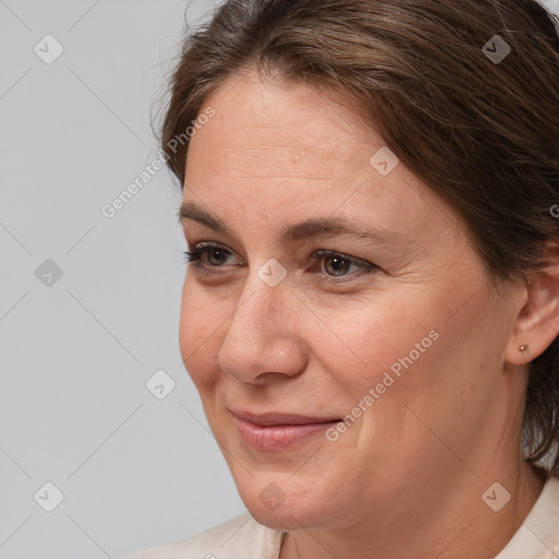 Joyful white adult female with medium  brown hair and brown eyes