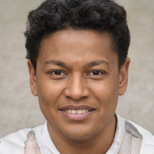Joyful latino young-adult male with short  brown hair and brown eyes