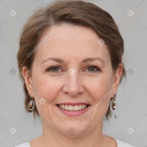 Joyful white adult female with medium  brown hair and grey eyes