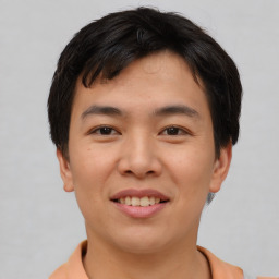 Joyful asian young-adult male with short  brown hair and brown eyes