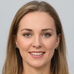 Joyful white young-adult female with long  brown hair and green eyes