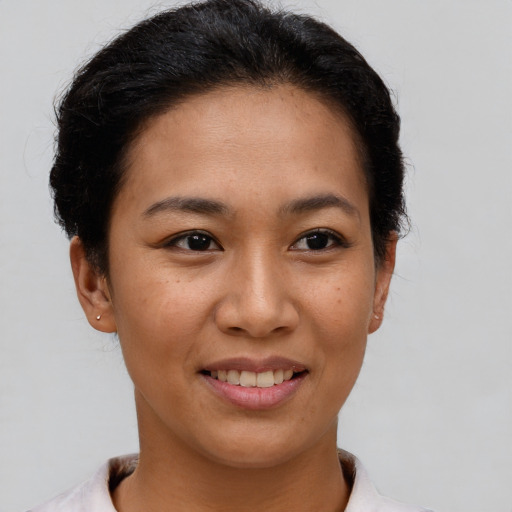 Joyful white young-adult female with short  brown hair and brown eyes