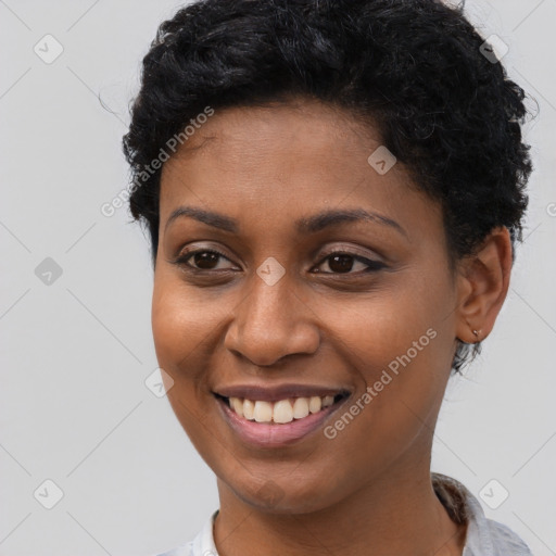 Joyful black young-adult female with short  black hair and brown eyes