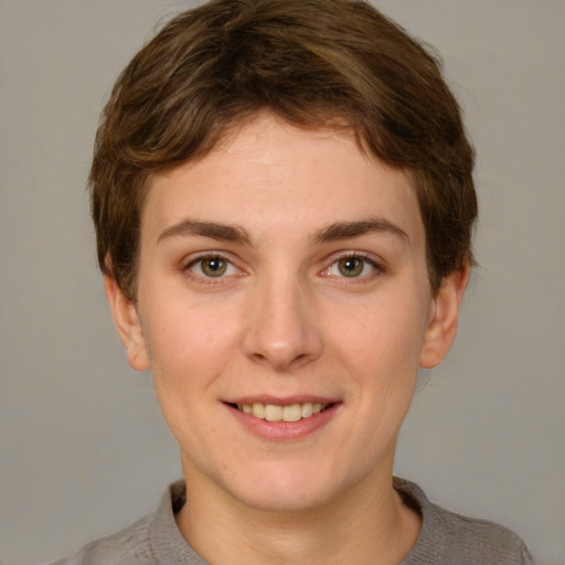 Joyful white young-adult female with short  brown hair and grey eyes