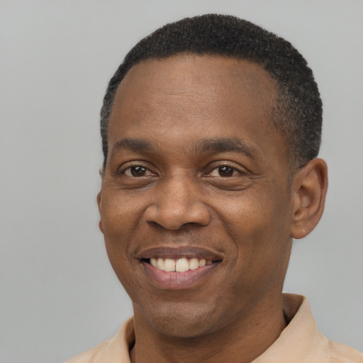 Joyful latino adult male with short  black hair and brown eyes