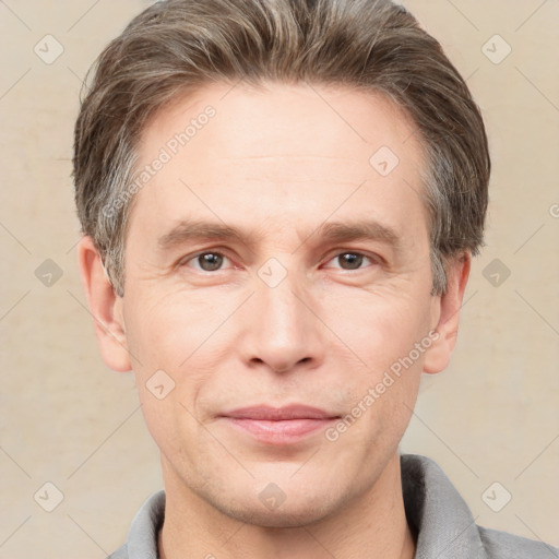 Joyful white adult male with short  brown hair and grey eyes