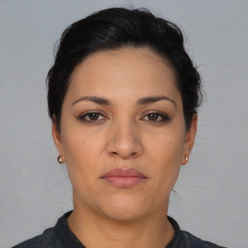 Joyful latino young-adult female with short  brown hair and brown eyes