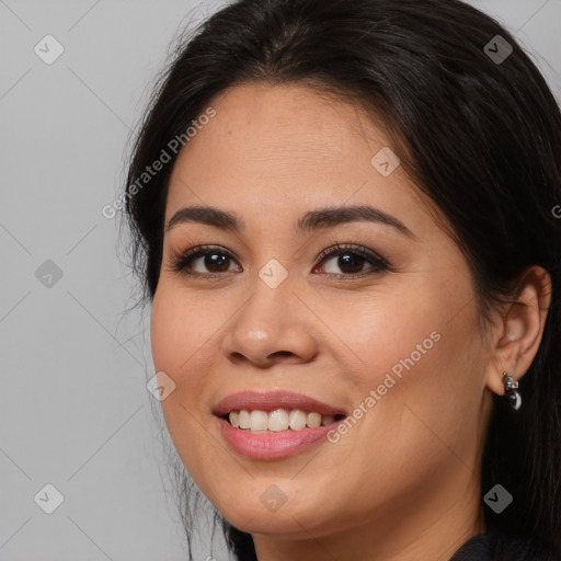 Joyful white young-adult female with long  brown hair and brown eyes