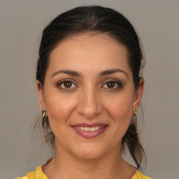 Joyful white young-adult female with medium  brown hair and brown eyes