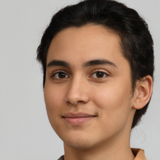 Joyful latino young-adult male with short  brown hair and brown eyes