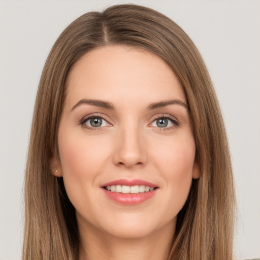 Joyful white young-adult female with long  brown hair and grey eyes