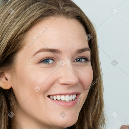 Joyful white young-adult female with long  brown hair and blue eyes