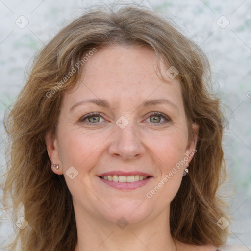 Joyful white adult female with medium  brown hair and blue eyes