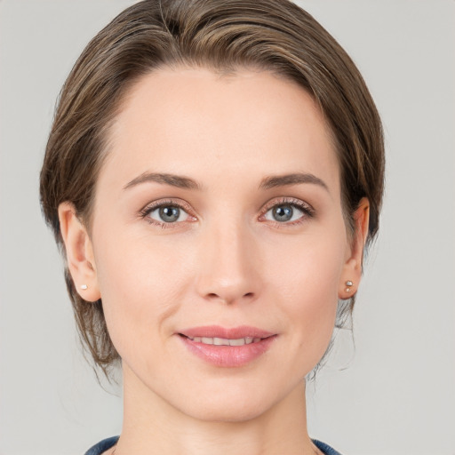 Joyful white young-adult female with medium  brown hair and grey eyes