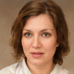 Joyful white young-adult female with medium  brown hair and green eyes