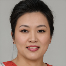 Joyful asian young-adult female with medium  brown hair and brown eyes