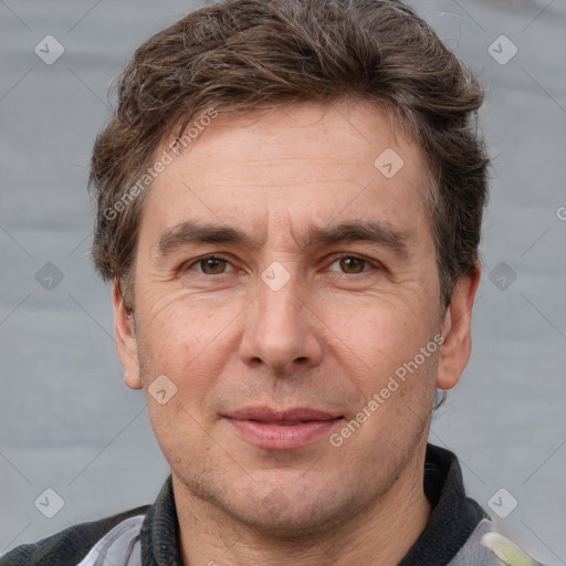 Joyful white adult male with short  brown hair and grey eyes