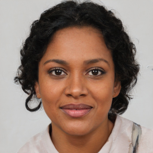 Joyful black young-adult female with medium  brown hair and brown eyes