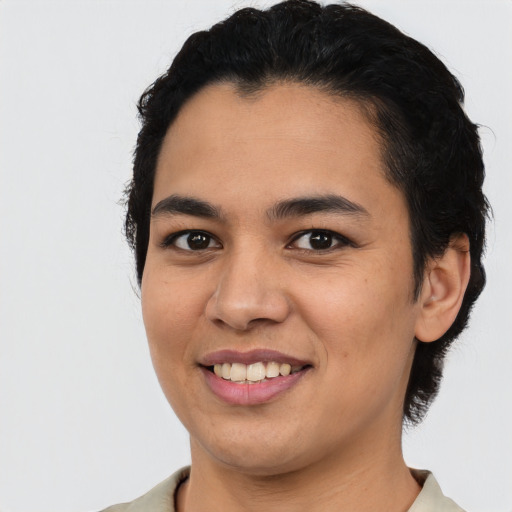Joyful latino young-adult female with short  black hair and brown eyes