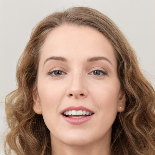 Joyful white young-adult female with long  brown hair and green eyes