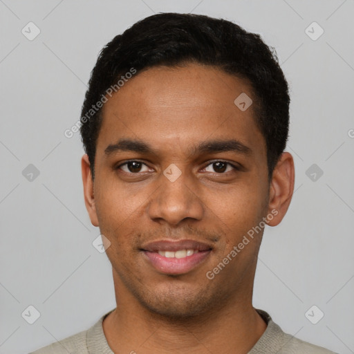 Joyful black young-adult male with short  black hair and brown eyes