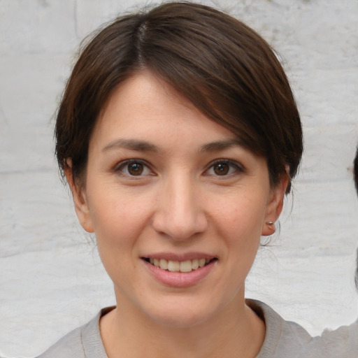 Joyful white young-adult female with medium  brown hair and brown eyes