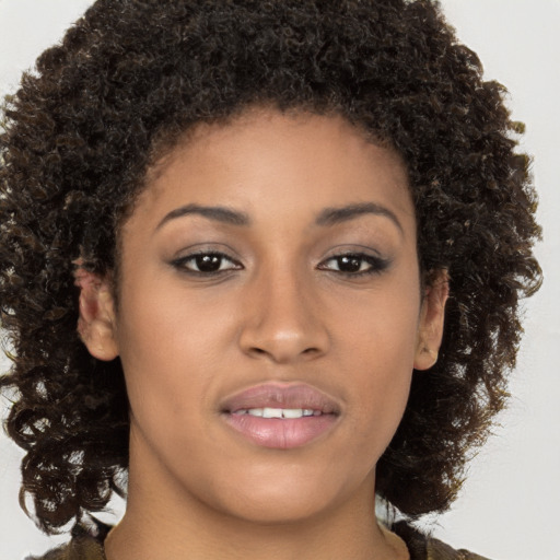 Joyful black young-adult female with medium  brown hair and brown eyes