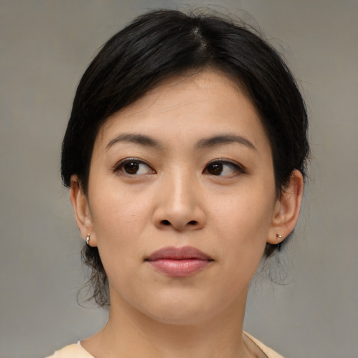 Joyful asian young-adult female with medium  brown hair and brown eyes