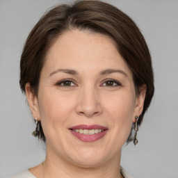 Joyful white adult female with medium  brown hair and brown eyes