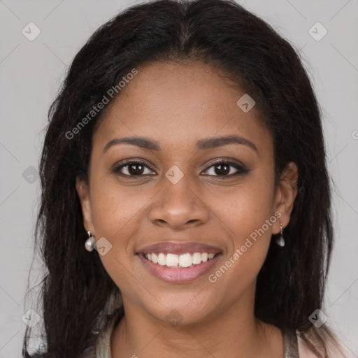 Joyful black young-adult female with long  brown hair and brown eyes