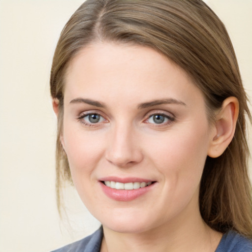 Joyful white young-adult female with medium  brown hair and blue eyes