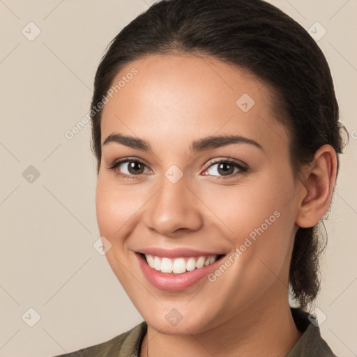 Joyful white young-adult female with long  brown hair and brown eyes