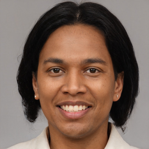 Joyful latino adult male with medium  black hair and brown eyes