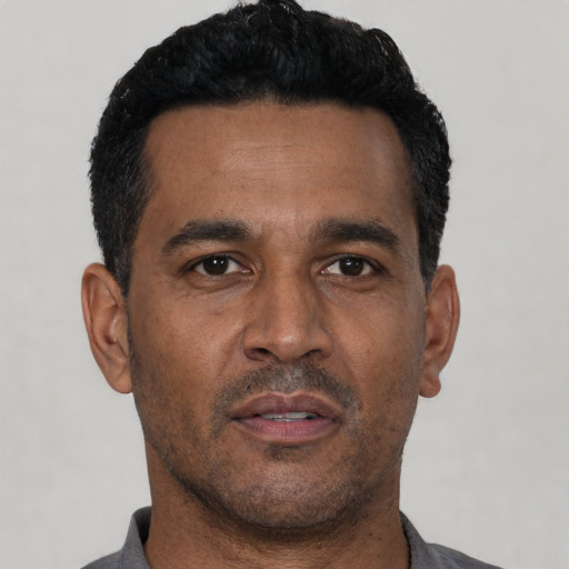 Neutral latino adult male with short  black hair and brown eyes