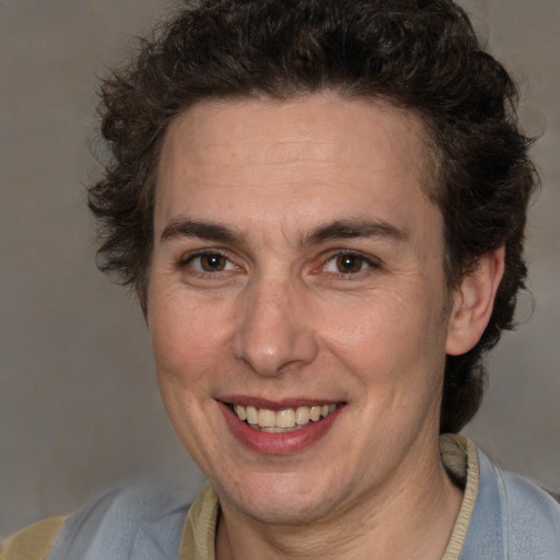 Joyful white adult male with medium  brown hair and brown eyes