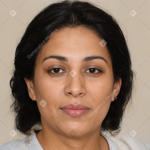 Joyful latino adult female with medium  brown hair and brown eyes