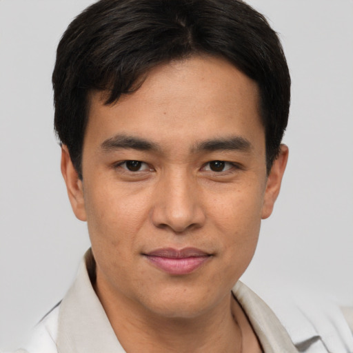Joyful asian young-adult male with short  brown hair and brown eyes