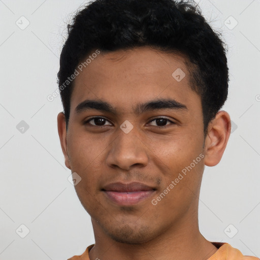 Joyful latino young-adult male with short  brown hair and brown eyes