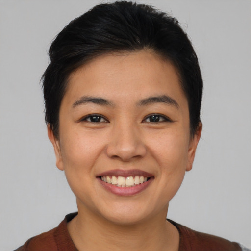 Joyful asian young-adult female with short  black hair and brown eyes