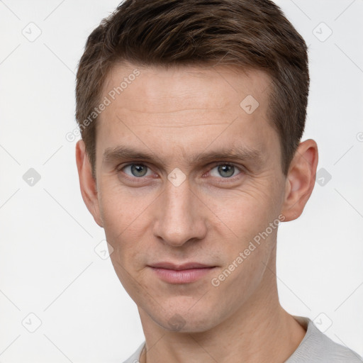 Joyful white young-adult male with short  brown hair and grey eyes